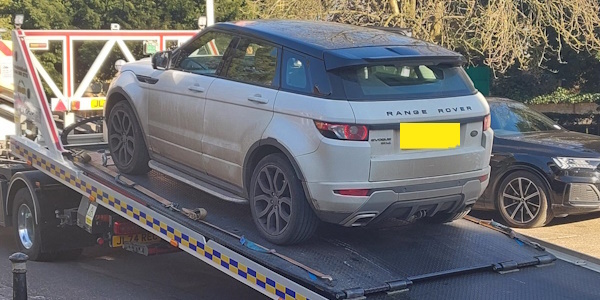 Silver Vehicle on a recovery truck 