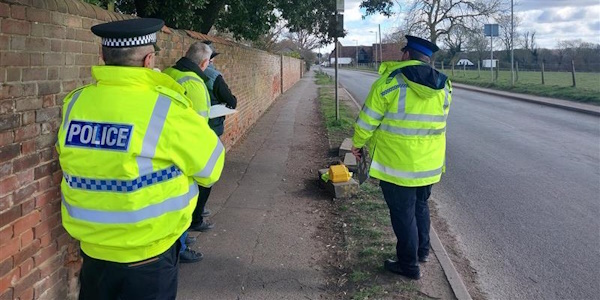 Members of community speed watch with the community policing team at the side of the road