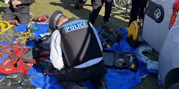 An officer looks at suspected stolen tools.