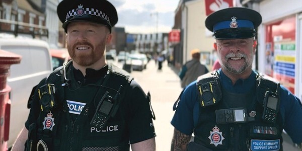 An police officer and a PCSO patrolling together along a high street