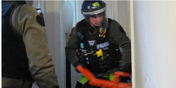 Officer forcing entry with a ram
