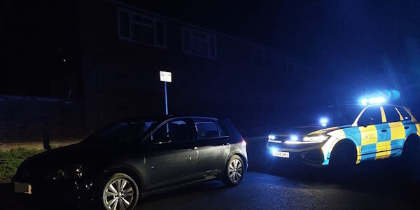 Police car has pulled over the driver in a black car