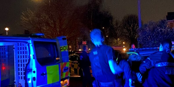 Officers detaining Rocky