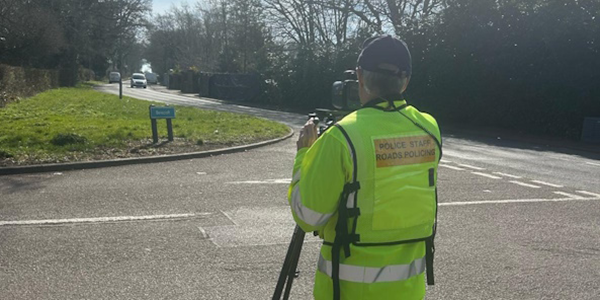 Police officer operating mobile speed check