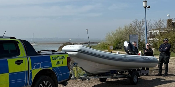 Marine unit truck and boat with officers in the background