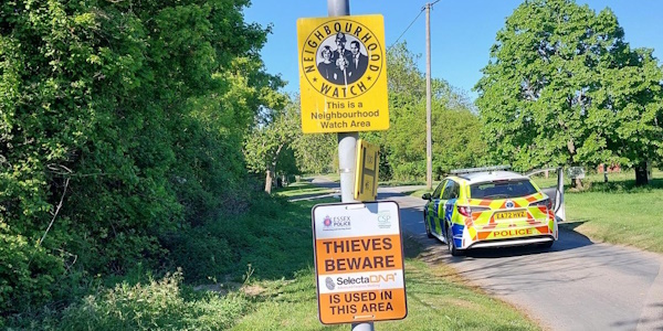 Street post with DNA Warning sign attached