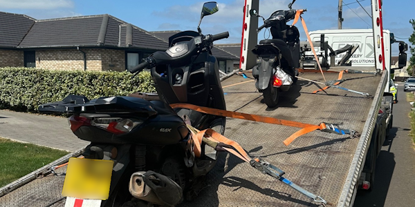 2 seized stolen mopeds on the rear of a recovery vehicle