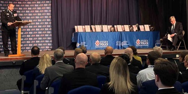Special Constables seated in a hall listening to ACC Stuart Hooper introducing the evening's award ceremony