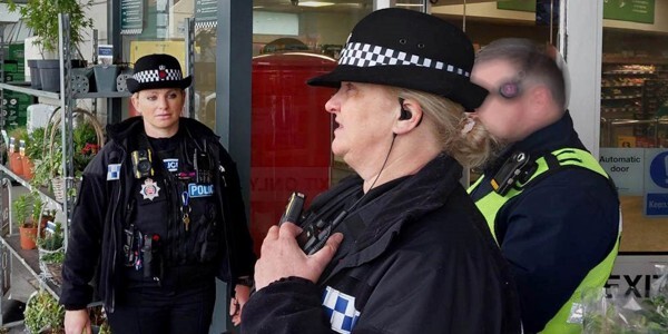 Neighbourhood police officers work with security at a shop in Clacton
