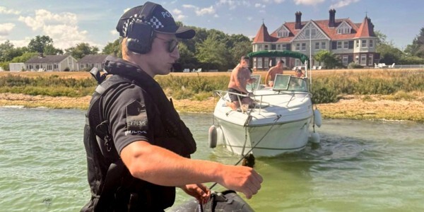 A Marine Unit officer prepares to tow a stricken boat