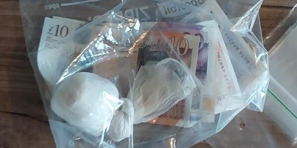 Plastic evidence bag with recovered drugs and money inside