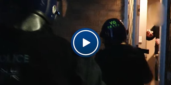 Officers at the front door of a house subject to a warrant in Colchester