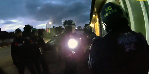 Police officers executing warrant during the early hours of the morning