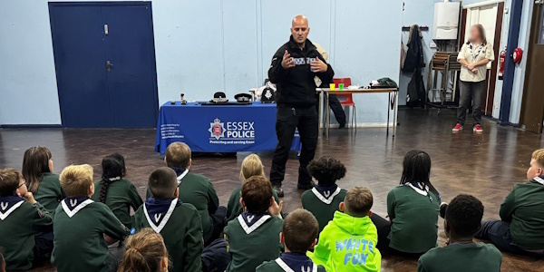 uniformed officer stood talking to Cubs group in Ockendon