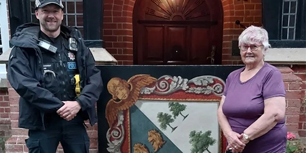 PC Dane Wyatt returns the funeral hatchment to St Margaret’s churchwarden Jan Nightingale