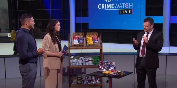 BBC Crimewatch Live presenters interviewing Sergeant Denning in a studio