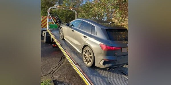 Car on the back of a transporter lorry
