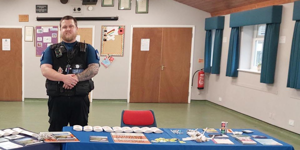 PCSO Stewart standing behind a table with DNA kits on