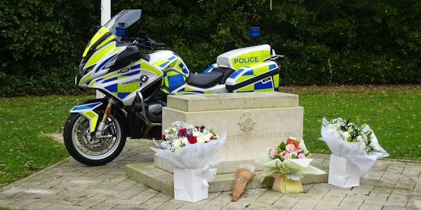 Essex Police Memorial Stone at Headquarters with a police motorcycle and flowers
