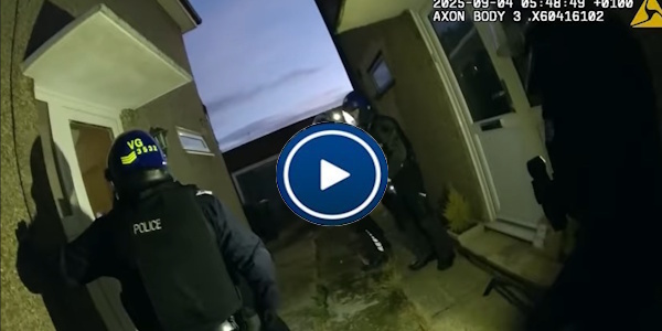 Officers at night gaining access and entering a house