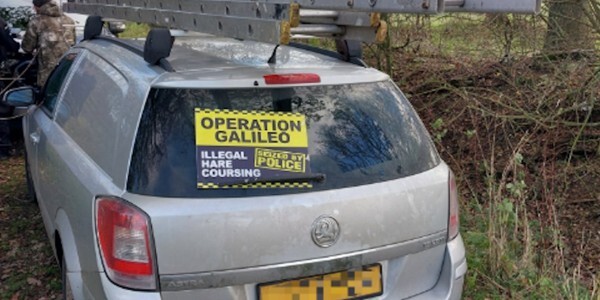 Silver estate car with ladder on roof rack seized