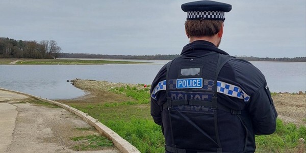 Police officer by the edge of Hanningfield Reservoir