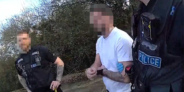 Man being arrested by police officers