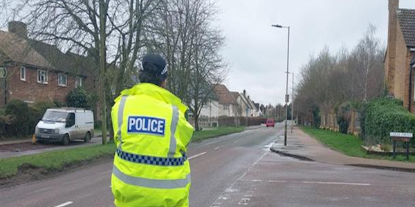 Police officer using a speed device on the roadside