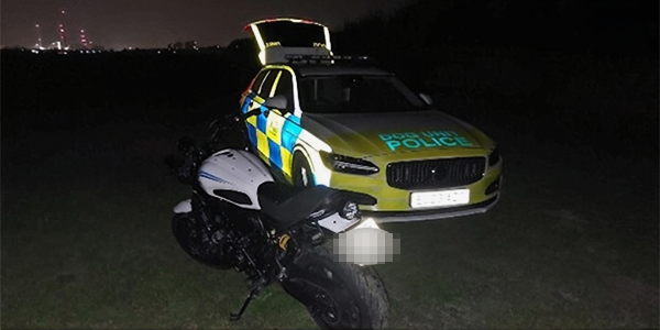 marked police car with stopped motorbike