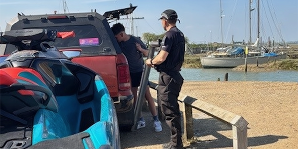 Marine Unit Officer speaking to person with personal watercraft 