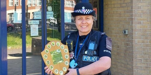 PC Carly Mond holding a trophy outside Colchester Police Station