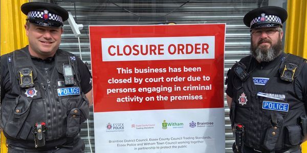 PC Steve Bright, left, and Sergeant Andy Christian, of Braintree Neighbourhood Policing Team with large closure order notice sign