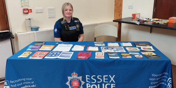 Essex Police officer at a recruitment table with leaflets and brochures
