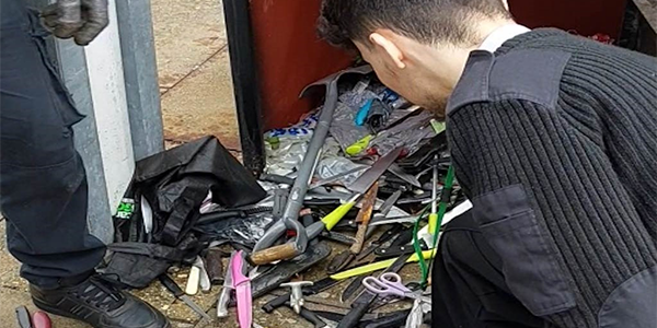 knives being removed from knife bin