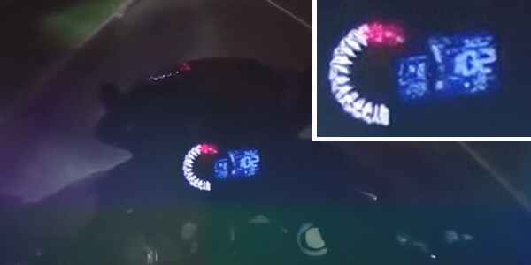 View from motorcyclist's point of view at night showing speed of 102 miles per hour on the speedometer.