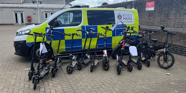 Police van with eleven seized e-scooters and an e-bike in front