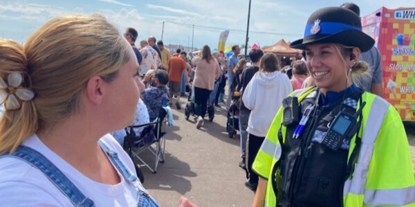Essex Police officer chatting to a member of the public on the seafront at Clacton