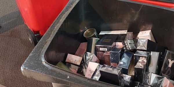 Boxes of perfume in a wheelie bin