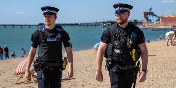 PC Windeatt and colleague walking along the beach at Southend-on-Sea