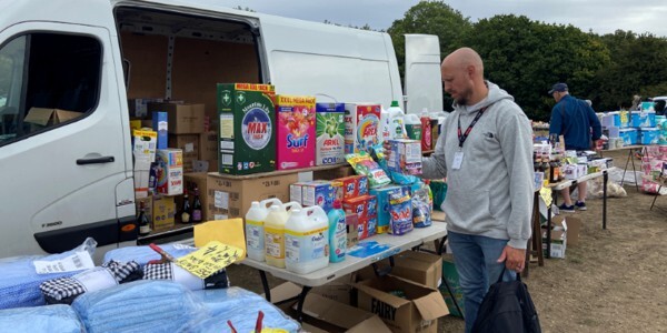 Police officers in plain clothes inspecting items for sale at a boot fayre