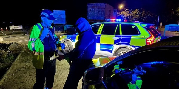 A man is arrested for drugs and weapons offences at night