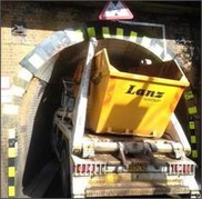 Skip lorry stuck under railway bridge