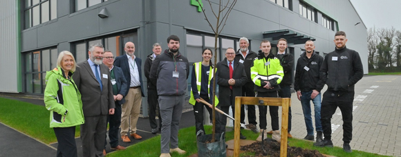 A group pf people standing outside of the new language units 