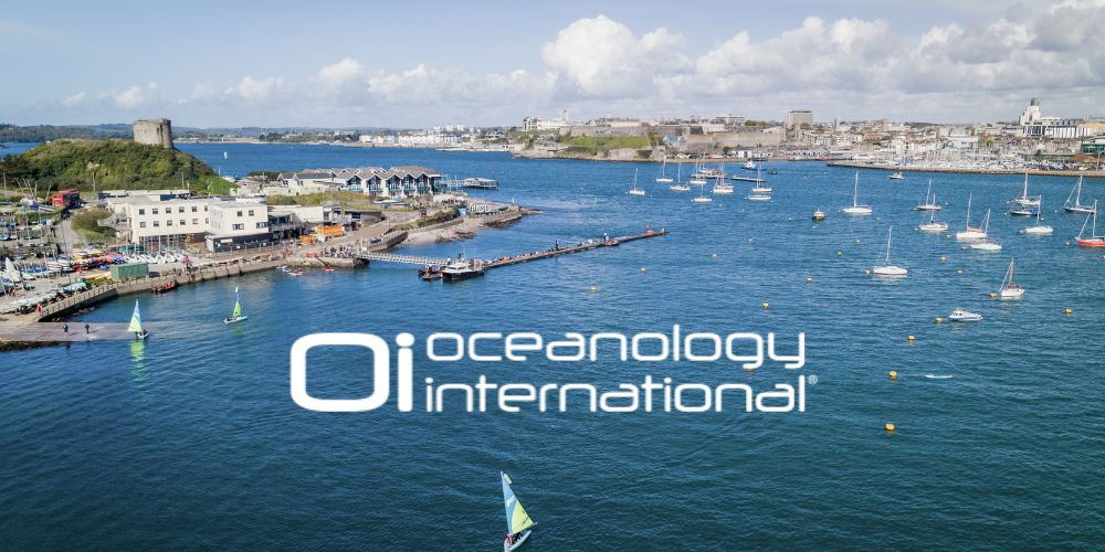 Aerial view of Plymouth Harbour featuring sailboats, marinas, a hilltop fort, and overlaid "Oi Oceanology International" branding.