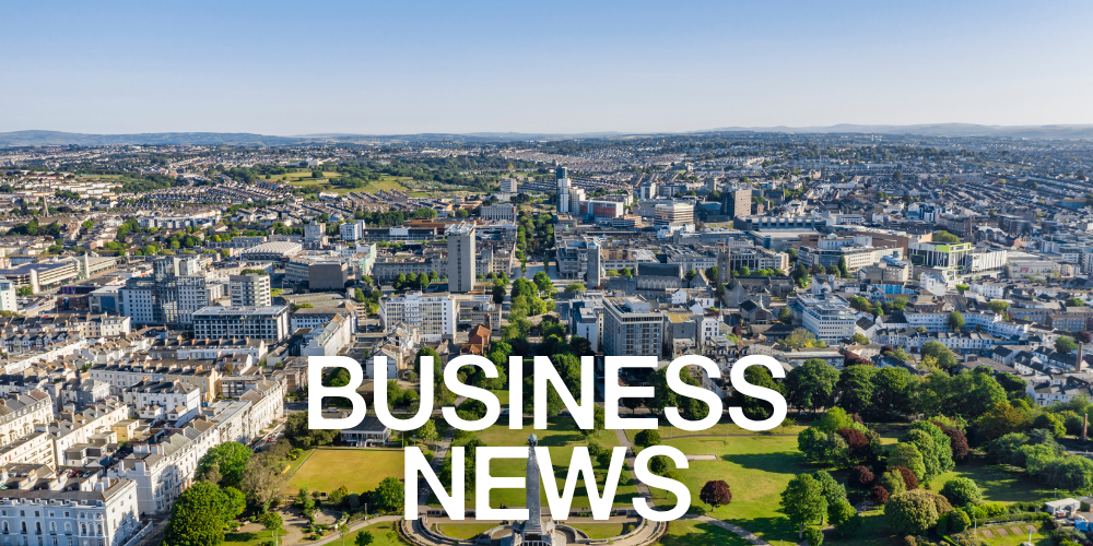 Aerial view of a city with “BUSINESS NEWS” text overlaid.
