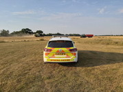 Police car in farmer's field