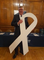 Roger Hirst Holding a white ribbon in support of White Ribbon Day