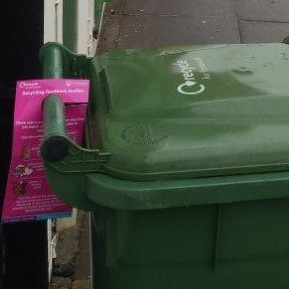 Red hanger recycling green bin