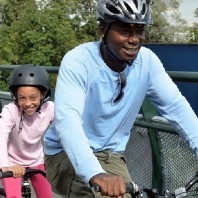 Man and young girl riding a bicycle