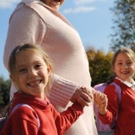 Girl traveling to school with adult